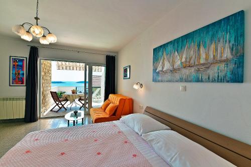 a bedroom with two beds and a living room with a table at Apartments Tamara in Hvar