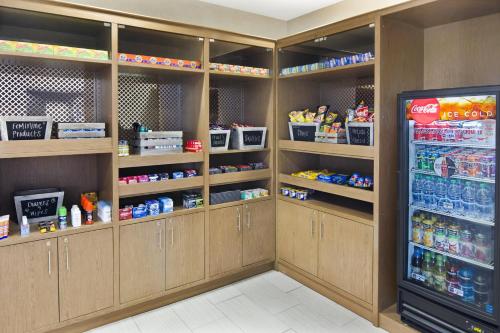 a room with wooden shelves and a refrigerator in a store at Holiday Inn Augusta West I-20 by IHG in Augusta