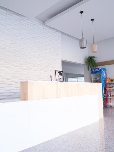a reception counter in a room with white walls at Luxe Villa in Ban San Ton Ko (1)
