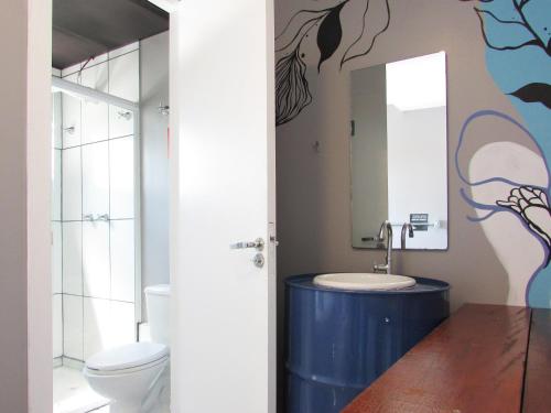 a bathroom with a sink and a mirror at Tetris Container Hostel in Foz do Iguaçu