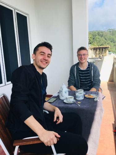 a couple of men sitting at a table at The Fern Inn in Nuwara Eliya