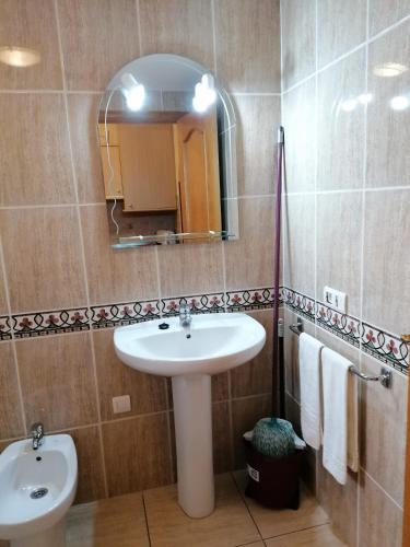 a bathroom with a sink and a mirror at Parque carolina estudio 203 in Costa Del Silencio
