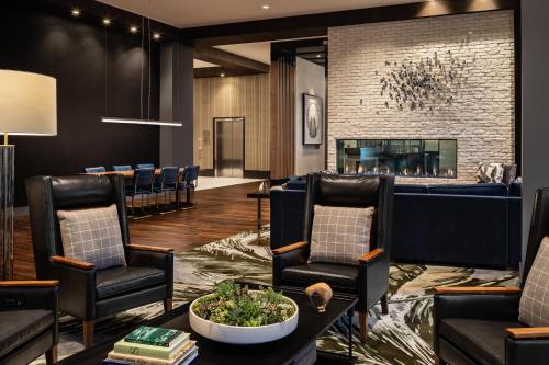 a waiting room with chairs and a fireplace at Crowne Plaza North Augusta, by IHG in North Augusta