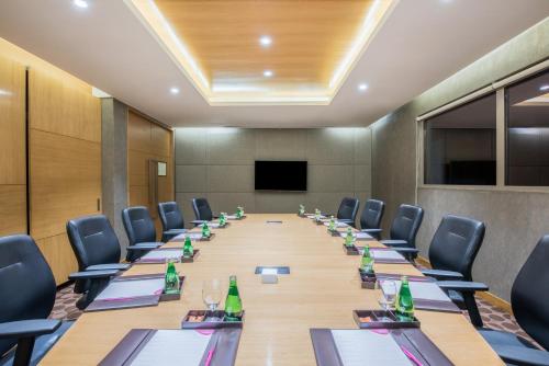 a conference room with a long table and chairs at Crowne Plaza Ahmedabad City Centre by IHG in Ahmedabad