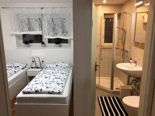 a bathroom with a bed and a shower and a sink at Ferber 28 in Monheim