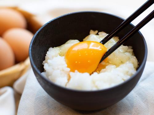 a bowl of rice with an egg on top at Natural Hot Spring Super Hotel Tottori Eki Kitaguchi in Tottori