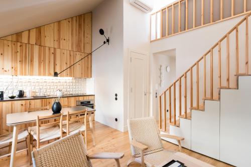 a kitchen and dining room with a table and chairs at Casas na Portuguesa - Bica Chiado in Lisbon