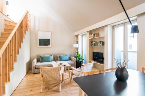 a living room with a couch and a table at Casas na Portuguesa - Bica Chiado in Lisbon