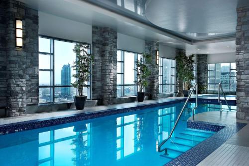 a swimming pool in a building with windows at Hyatt Regency Calgary in Calgary