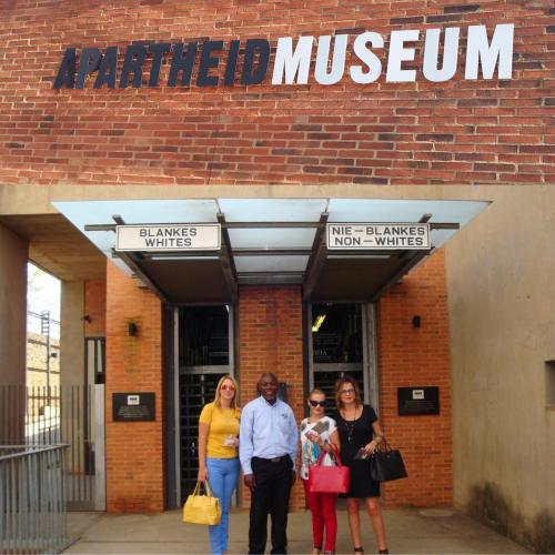 a group of people standing in front of aoked museum at The Great Gatsby Houghton in Johannesburg