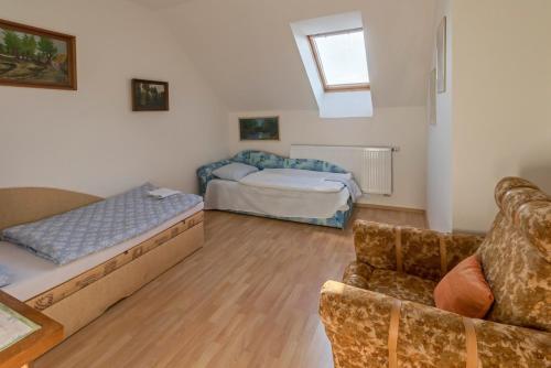 a living room with a couch and a bed at Apartmán GARDEN in Lednice