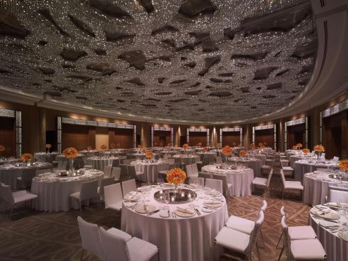 a banquet hall with white tables and white chairs at Grand Hyatt Kuala Lumpur in Kuala Lumpur