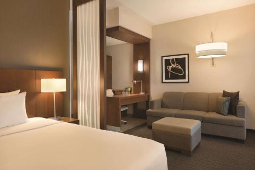 a hotel room with a bed and a couch at MARINN PLACE Financial District in Panama City