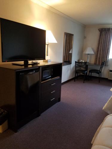a hotel room with a flat screen television on a dresser at French Creek Inn in Phoenixville
