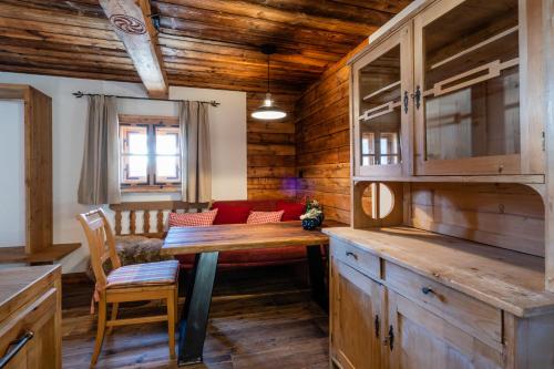 a living room with a wooden table and a couch at Bergappartements Pröll in Kleinarl