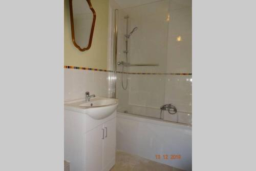 a bathroom with a shower and a sink and a tub at Lovely old cottage in Stratford-upon-Avon