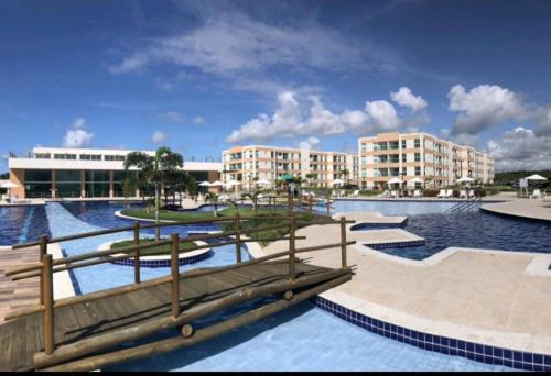 a resort swimming pool with buildings in the background at Porto de Galinhas - Muro Alto Condomínio Clube in Ipojuca