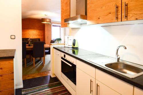 a kitchen with a sink and a counter top at Ferienhaus Schnitzhof in Abtenau