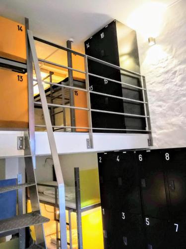 a stack of bunk beds in a room with a ladder at Sleep in Heaven in Copenhagen