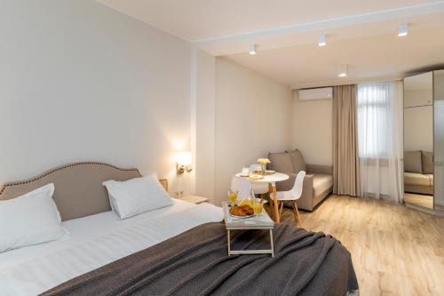 a hotel room with a bed and a table at Pomegranate in Old Tbilisi in Tbilisi City