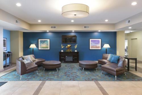 a waiting room with couches chairs and a fireplace at Candlewood Suites Odessa by IHG in Odessa