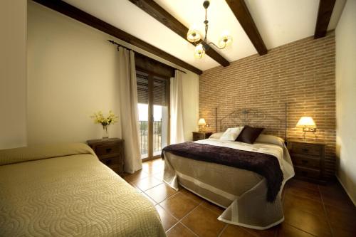 Ένα ή περισσότερα κρεβάτια σε δωμάτιο στο Casas Rurales Arribes Durii