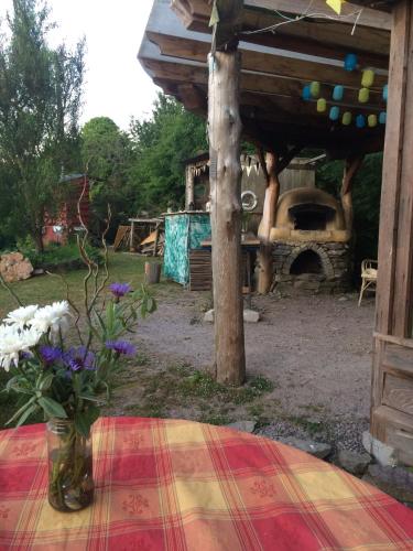 a vase of flowers sitting on a table with a table cloth at Inch Hideaway Eco Camping in Whitegate
