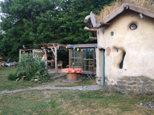 a small house with a bench in a yard at Inch Hideaway Eco Camping in Whitegate