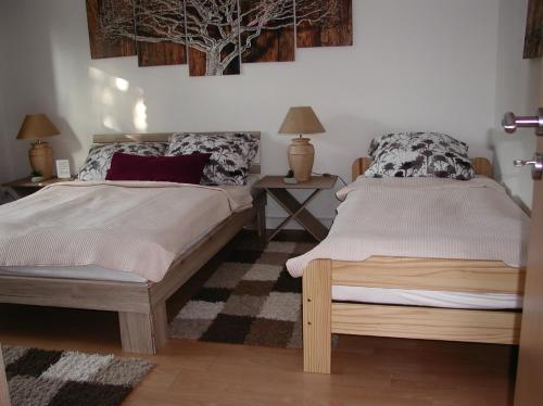 1 Schlafzimmer mit 2 Betten und 2 Tischen mit Lampen in der Unterkunft Ferienwohnung Schmidt in Friesoythe