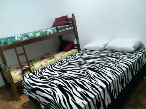 En eller flere senge i et værelse på Residencial Fênix