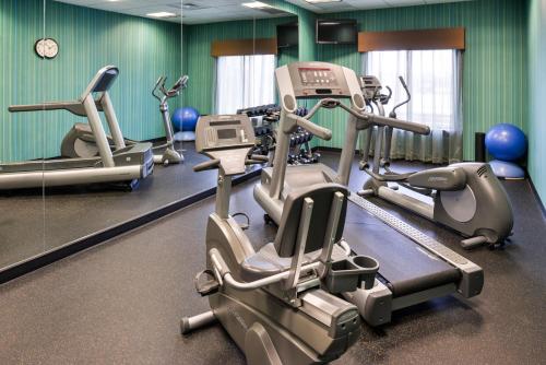 a gym with several tread machines and a mirror at Holiday Inn Express Hotel & Suites Wichita Falls, an IHG Hotel in Wichita Falls