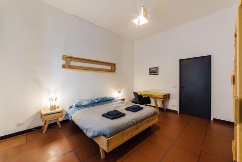 a bedroom with a bed and a desk in it at Palazzo Verrone in Bari