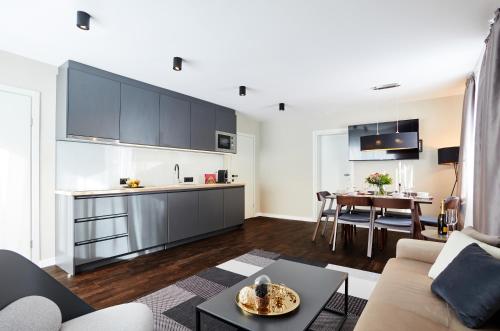 a kitchen and living room with a couch and a table at das Valdo in Seefeld in Tirol