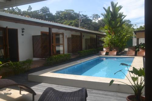 a swimming pool in front of a house at Hotel Indalo adults only in Puerto Viejo