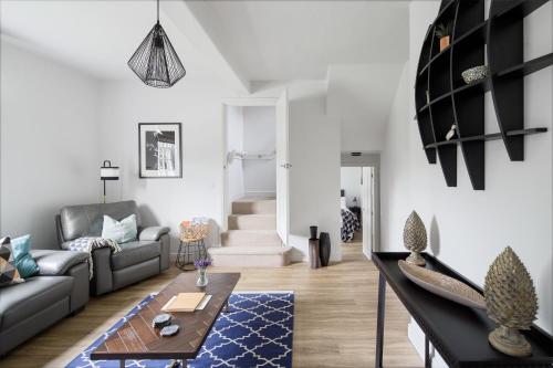 a living room with a couch and a table at Harewood Estate Cottages in Harewood