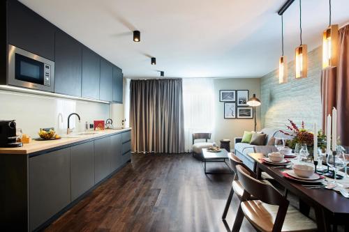 a kitchen and living room with a table and a couch at das Valdo in Seefeld in Tirol