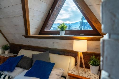 a living room with a couch and a window at Chałpa u Zbójnika in Zakopane