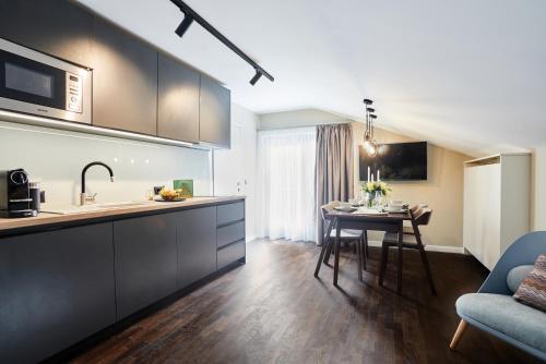 a kitchen and living room with a table and a couch at das Valdo in Seefeld in Tirol