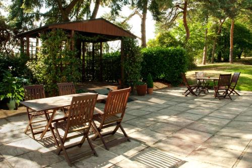 a patio with a table and chairs and a gazebo at Holiday Inn Ashford - North A20 by IHG in Ashford