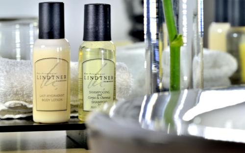 three bottles of moisturizers sitting on a shelf at Privathotel Lindtner Hamburg in Hamburg