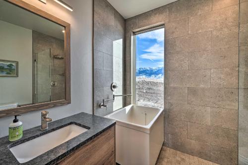 a bathroom with a sink and a tub and a window at Secluded Paradise Valley Retreat with Stunning Views in Livingston