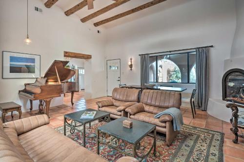a living room with a couch and a piano at Adobe House with Patio - Walk to Dtwn Plaza and Shops! in Santa Fe