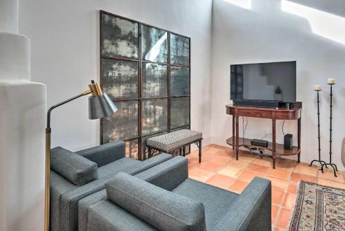 a living room with a couch and a tv at Adobe House with Patio - Walk to Dtwn Plaza and Shops! in Santa Fe