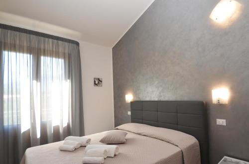 a bedroom with two beds with towels on them at Le Falesie di Castelluzzo in Castelluzzo