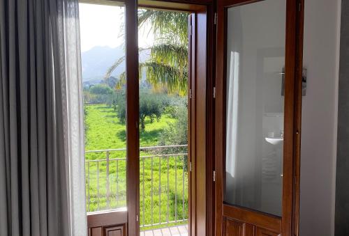 a room with a window with a view of a field at Le Falesie di Castelluzzo in Castelluzzo
