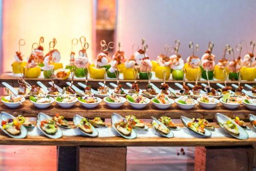a buffet with plates of food on a table at Intercontinental Miramar Panama by IHG in Panama City