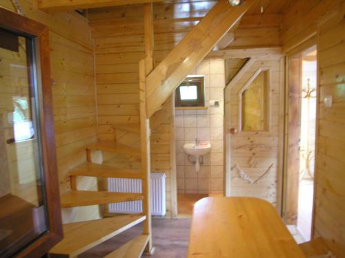 a bathroom with a staircase in a wooden house at Mały domek pod lasem in Zakopane
