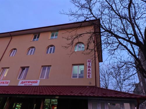 a building with a sign on the side of it at Mirage in Chernivtsi