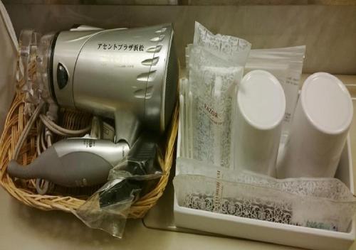 a basket with a hair dryer and other items in it at Hotel Ascent Plaza Hamamatsu / Vacation STAY 64697 in Hamamatsu
