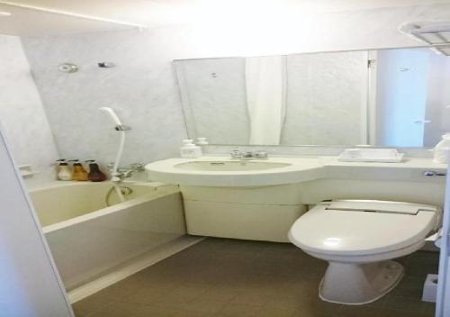 a bathroom with a toilet and a sink and a bath tub at Hotel Ascent Plaza Hamamatsu / Vacation STAY 64700 in Hamamatsu